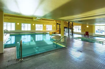 a large swimming pool in a large building at Ramada by Wyndham Cranbrook in Cranbrook