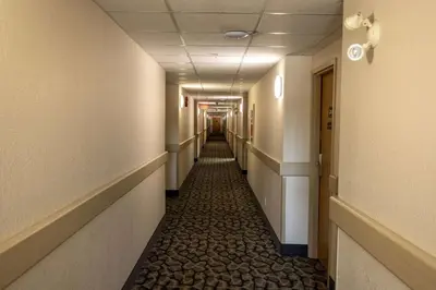 a corridor of a hospital hallway with a long aisle at Ramada by Wyndham Cranbrook in Cranbrook