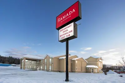a sign in the snow in front of a building at Ramada by Wyndham Cranbrook in Cranbrook