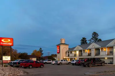 a parking lot with cars parked in front of a hotel at Econo Lodge in Edson
