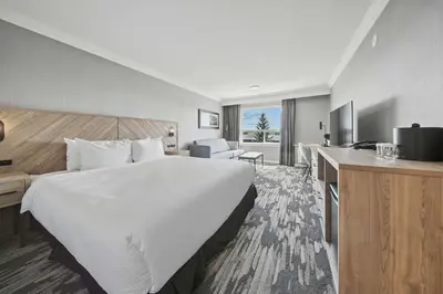 a hotel room with a large bed and a desk at Sandman Hotel Red Deer in Red Deer