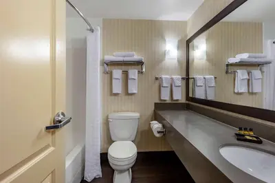 a bathroom with a toilet and a sink at Best Western Plus Meridian in Lloydminster