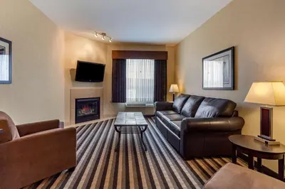 a living room with a couch and a fireplace at Best Western Plus Meridian in Lloydminster