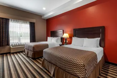 a hotel room with two beds and a red wall at Best Western Plus Meridian in Lloydminster