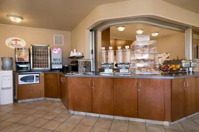a kitchen with a counter with aasteryasteryasteryasteryasteryasteryasteryasteryastery at Super 8 by Wyndham Fort Nelson BC in Fort Nelson
