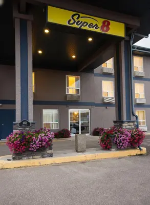 a store front with flowers in front of it at Super 8 by Wyndham Whitecourt in Whitecourt