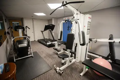 a gym with several exercise equipment in a room at Super 8 by Wyndham Whitecourt in Whitecourt