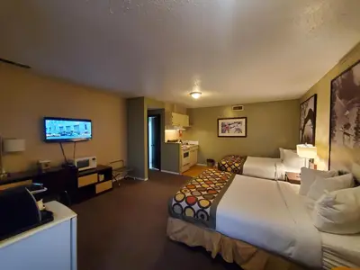 a hotel room with two beds and a flat screen tv at Super 8 by Wyndham Duncan in Duncan