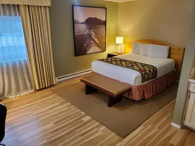 a hotel room with a bed and a window at Super 8 by Wyndham Duncan in Duncan