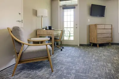 an office with a desk and a chair and a table at Balcomo, a Ramada by Wyndham in Penticton
