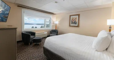 a hotel room with a bed and a window at Prestige Oceanview Hotel Prince Rupert in Prince Rupert
