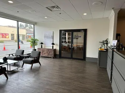 an empty office with a table and chairs and a room at Prestige Oceanview Hotel Prince Rupert in Prince Rupert