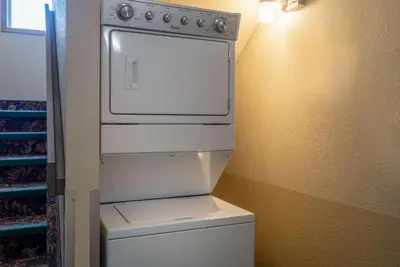 a kitchen with a white stove in a room at Super 8 by Wyndham Edmonton International Airport in Leduc