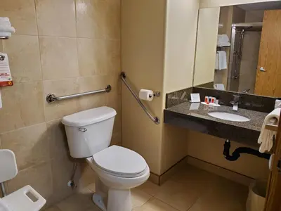 a bathroom with a toilet and a sink at Super 8 by Wyndham Edmonton International Airport in Leduc