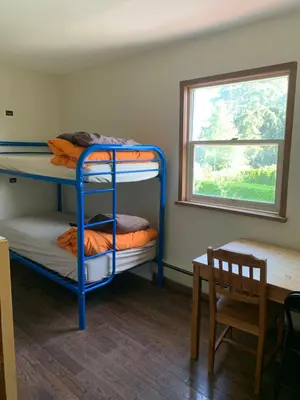 two bunk beds in a room with a window at Vancouver Backpacker House - 10 min walk to Metrotown skytrain station in Burnaby