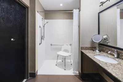 a bathroom with a sink and a shower at Best Western Premier Freeport Inn Calgary Airport in Calgary