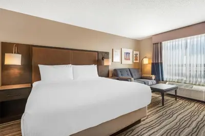 a large white bed in a hotel room at Best Western PLUS Calgary Centre Inn in Calgary