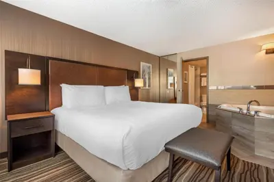 a hotel room with a bed and a bath tub at Best Western PLUS Calgary Centre Inn in Calgary