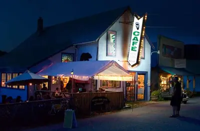 a building with a sign for a restaurant at night at Mountain Thyme Getaway in Barkerville