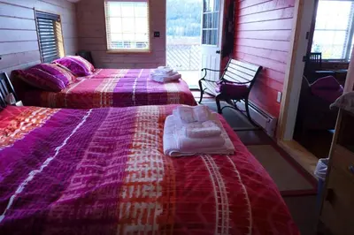 a bedroom with two beds with towels on them at Mountain Thyme Getaway in Barkerville