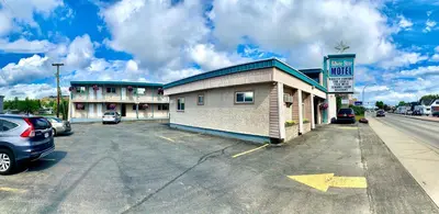 a car parked in a parking lot next to a motel at Silver Star Motel in Vernon