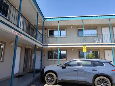 a silver car parked in front of a building at Silver Star Motel in Vernon