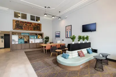 a living room with a couch and a table at Holiday Inn Victoria - Elk Lake by IHG in Victoria