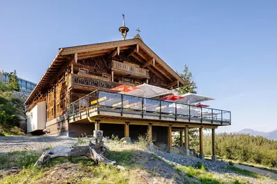 a building with a deck with umbrellas on it at Sparkling Hill Resort and Spa - Adults-Only Resort in Vernon