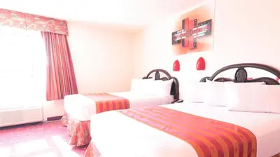 a hotel room with two beds and a window at Crystal Star Inn Edmonton Airport with free shuttle to and from Airport in Leduc