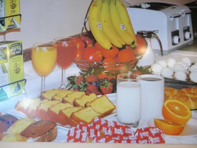 a plate of food with glasses of milk and fruit at Crystal Star Inn Edmonton Airport with free shuttle to and from Airport in Leduc