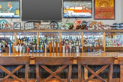 a bar filled with lots of bottles of beer at The Bedford Regency Hotel in Victoria