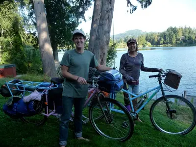 a man and woman standing next to their bikes at Cycle Inn Bed and Breakfast in Langford