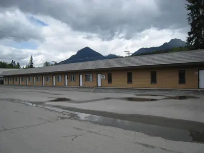 a large building with mountains in the background at Mary's Motel in Golden