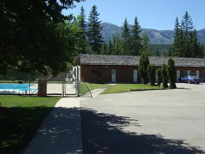 a building with a pool in front of a driveway at Mary's Motel in Golden