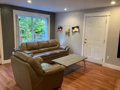a living room with a couch and a table at Sienna's Tree House (Tall Trees And Salty Breeze) in Tofino