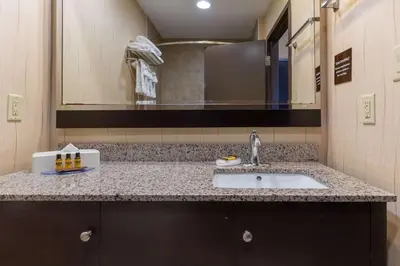 a bathroom with a sink and a mirror at Best Western Plus South Edmonton Inn & Suites in Edmonton