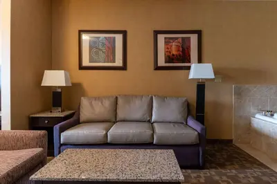 a living room with a couch and a tub at Best Western Plus South Edmonton Inn & Suites in Edmonton