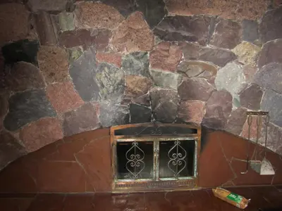 a stone wall with a window in a room at The Lodge At Skeena Landing in Terrace