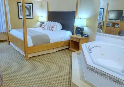 a hotel room with a bed and a bath tub at Best Western Plus Regency Inn and Conference Centre in Abbotsford