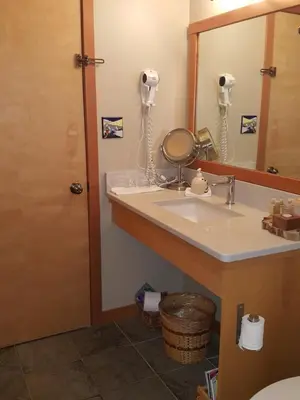 a bathroom with a sink and a mirror at Reef Point Oceanfront Bed and Breakfast in Ucluelet
