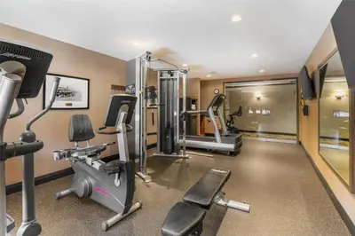 a gym with treadmills and elliptical machines at Best Western Plus Country Meadows Inn in Aldergrove