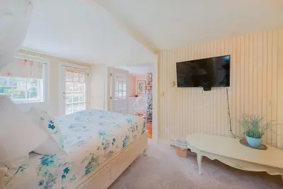 a bedroom with a bed and a tv on a wall at Beaconsfield Bed and Breakfast - Victoria in Victoria