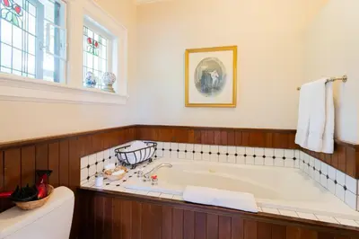 a large bathroom with a tub and a window at Beaconsfield Bed and Breakfast - Victoria in Victoria
