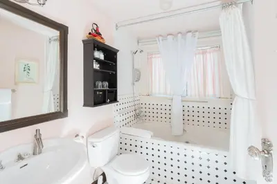 a bathroom with a tub and a toilet and a sink at Beaconsfield Bed and Breakfast - Victoria in Victoria