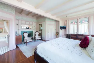 a bedroom with a bed and a table and chairs at Beaconsfield Bed and Breakfast - Victoria in Victoria