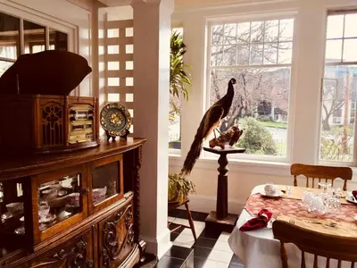 a living room with a bird statue and a table at Beaconsfield Bed and Breakfast - Victoria in Victoria