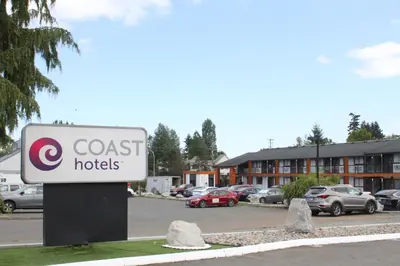 a sign for a coast hotel in a parking lot at Coast Courtenay Hotel in Courtenay