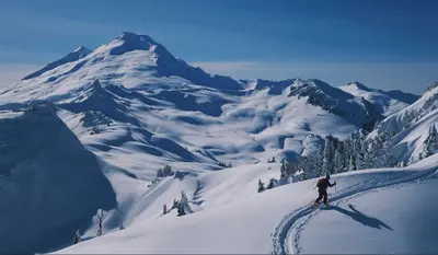 a person is skiing down a snow covered mountain at Alpine Inn Abbotsford in Abbotsford