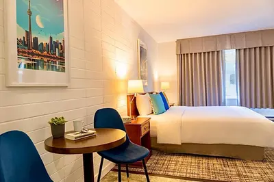a hotel room with a bed and a table and chairs at August Jack Inn in Squamish