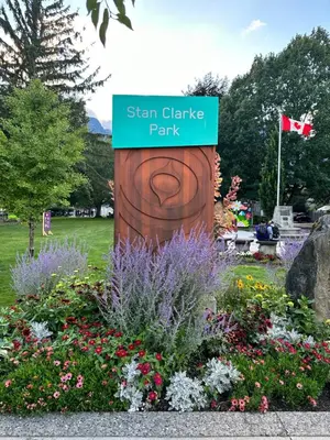 a sign for a garden with flowers in a park at August Jack Inn in Squamish